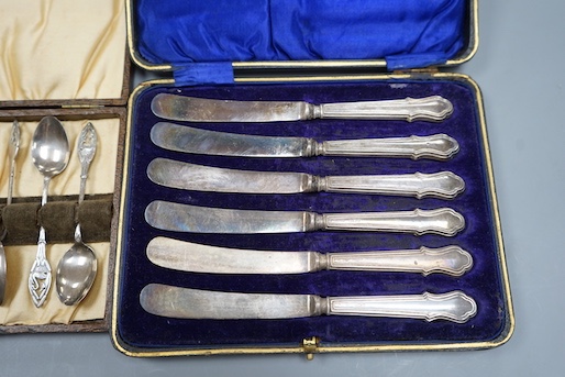 A set of six silver coffee spoons and a set of six silver handled tea knives